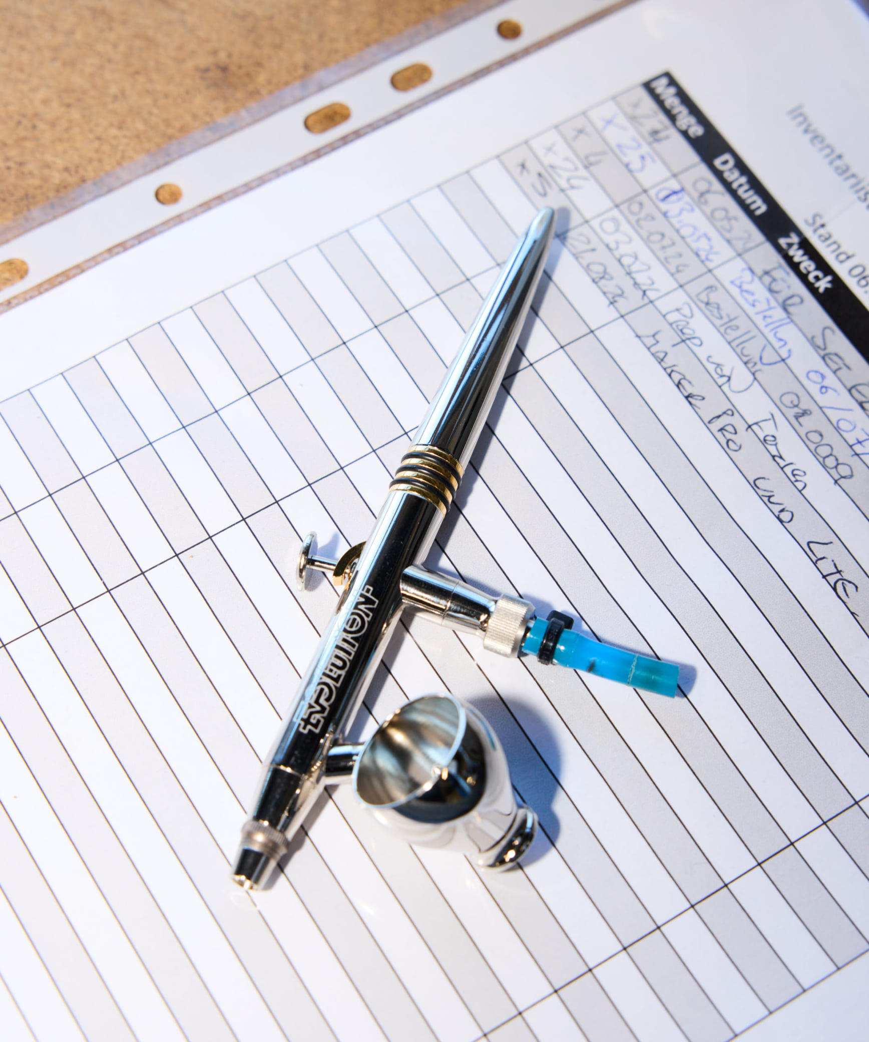 A carbon golf club prototype on top of technical sketches