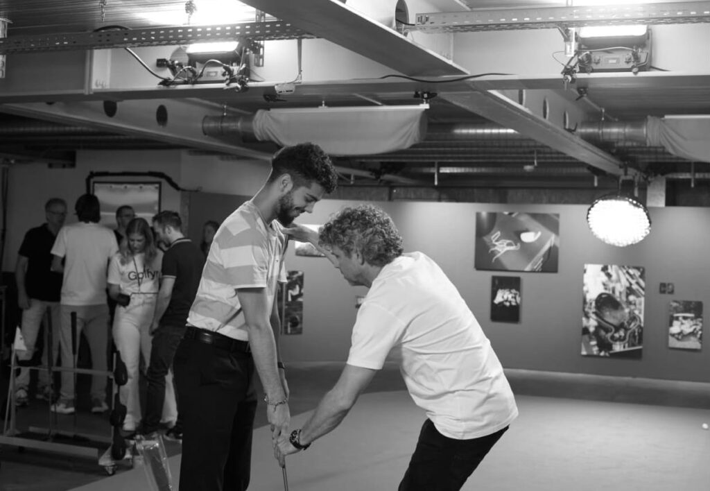 A visitor from the Ryder Cup Public Viewing 2023 in Zurich receiving a quick putting lesson from Olivier Widrig (Head of Golf)