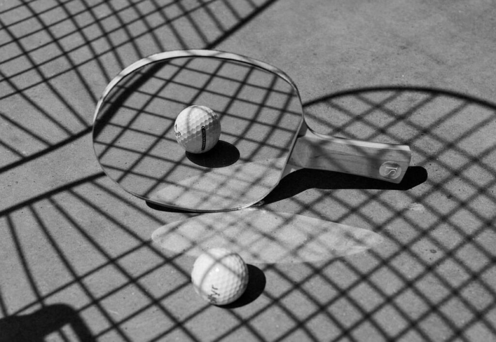 A branded Golfyr golf ball reflected in a table tennis bat